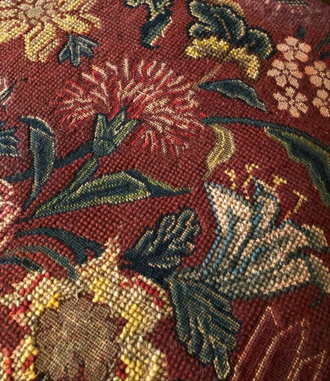 This is a close-up detail of the embroidery for original covers on two English walnut tree chairs, dating to circa 1735. Cross- and tent stitches with wool threads formed carnations, tulips and other flowering garden plants on a coarse linen canvas ground, also known as canvas-work. It is noticeable too, that some areas – of the depicted carnation for instance – were intentionally left without stitches, which intended to give the embroidery a three-layered special effect. Such embroideries were popular for upholstery on household furnishing in well-to-do and wealthy homes during the period. (Collection: David Collection in København, Denmark. No. 29a-b/1972). Photo: Viveka Hansen, The IK Foundation.