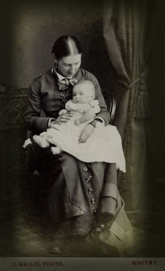 One rare example in Whitby Museum’s Photographic Collection is this Carte de Visite from the ‘Waller Pier Portrait Rooms Whitby’, a firm that operated as both a ‘Photographer & Miniature Painter’. Judging by the woman’s dress, this photograph of a mother and child originates from the 1870s, with the child’s voluminous christening gown carefully spread across the mother’s knee. (Courtesy: Whitby Museum…, Photographic Collection, Carte de Visite 29).