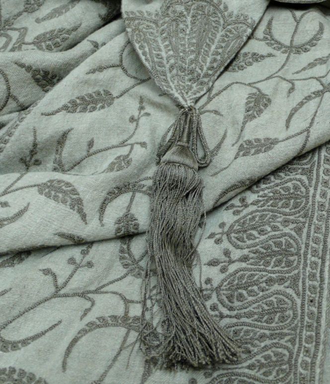 Close-up image of the grey woollen dolman with its intricate embroidery in tone with the fabric. The stitching with its “Eastern” inspired leaf motif is machine-made while the garment over all is completed with both hand and machine stitching. The hood is finished of with this beautiful silk tassel, centred in the image. (Whitby Museum, Costume Collection, no number at time of research). Photo: The IK Foundation, London.