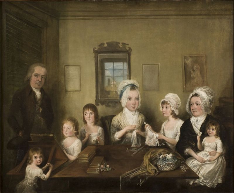 This inviting group portrait by the Swedish artist Elias Martin (1739-1818), shows the LaTrobe family and their textile handicraft with various sewing and embroidery projects together with the reading of books and even the smallest child holds an educational card with the letter H, whilst the father keeps a watching eye. To display an interest in book learning and handicraft was not unusual in paintings of the time and this particular family was portrayed by Elias Martin in the London area in the early 1770s. The Swedish artist stayed for more than 10 years in England after educational years in Le Havre, Paris and Rome – as well as being back in London in the years 1788 to 1791, after which returning to Stockholm where he came to stay for the rest of his life. Benjamin Bonneval LaTrobe (1728-1796), his wife Anna Margaretta LaTrobe (1728-1794), five of their six children and the nursemaid were all included in this informative picture. | Oil on canvas, named ‘Portrait of the Family LaTrobe of Fulneck’ in West Yorkshire, England. (Courtesy: National museum, Stockholm, Sweden. NM 6949. Wikimedia Commons).