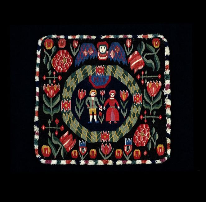 The centre part of this beautiful flamskväv cushion (50x50cm) was the original source and inspiration for  this reproduction. This original tapestry is also unusually well-preserved in colour as well as its linen  warp, woollen weft, back of woollen twill and fringe. It was woven in southernmost Sweden; Torna  district, Skåne. (Courtesy of: Kulturen in Lund, KM 24616, Creative Commons).