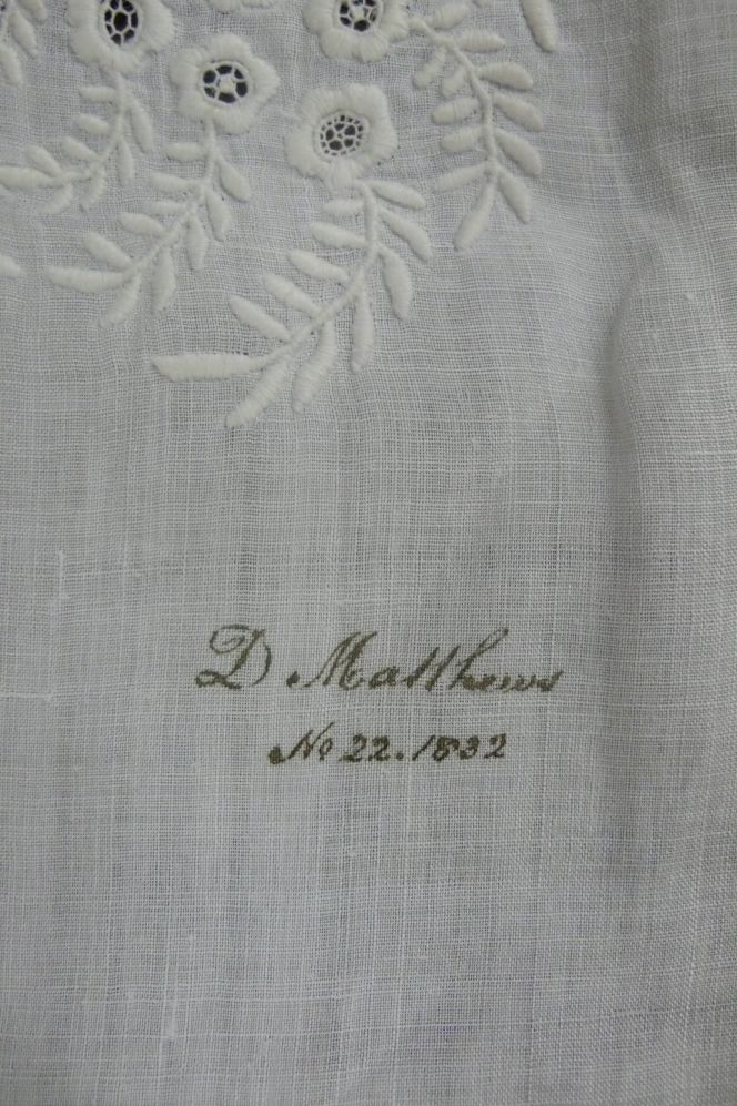 This piece of embroidery marked in ink, featuring satin stitch and drawn thread work sewn on the finest  cotton fabric to decorate a handkerchief. (Whitby Museum, Costume Collection, unnumbered at  time of research). Photo: Viveka Hansen.