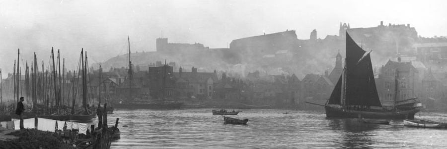 A view across the Whitby upper harbour, taken by Frank Meadow Sutcliffe in the 1890s. The atmospheric photograph visualises the typical variety of schooners, brigs, sloops and rowing boats in this small town harbour – where River Esk empties into the North Sea. (Courtesy: Whitby Museum, Photographic Collection, Sutcliffe 13-48, part of photograph).