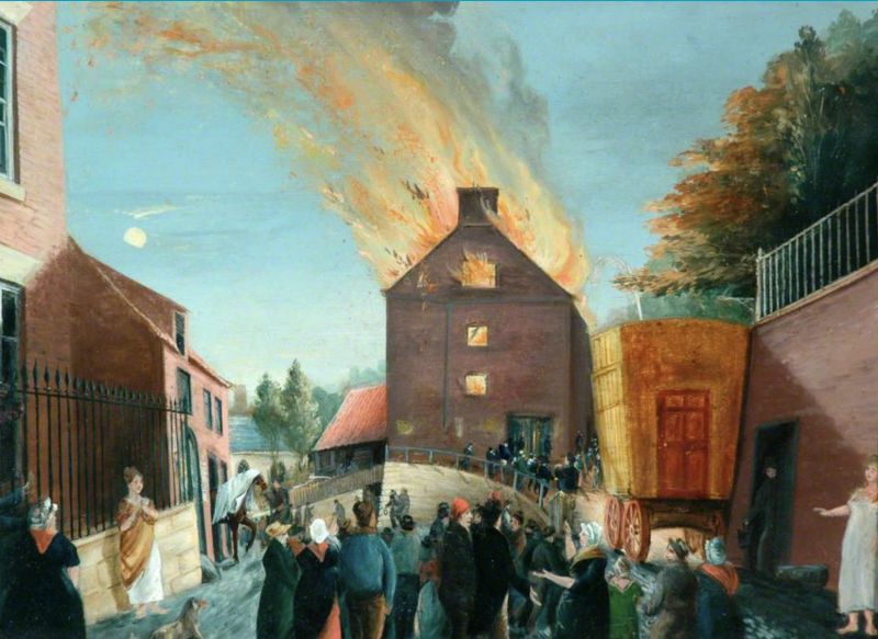 Fire at the Theatre at Skate Lane [today Brunswick Street] in 1823, oil on board by the local artist George Chambers (1803-1840). The painting shows groups of people, mostly fully dressed in outdoor clothes and hats, while two ladies seem to have rushed into the street in such a hurry that they are wearing only their linen shifts. This theatre was later replaced by the nearby Freemason’s Tavern’ at Baxtergate. Still, a theatre had existed in Whitby for many years, described in detail by the local historian George Young (1777-1848) in 1817. His publication, among other matters, stated: ’The first theatre in Whitby was in the Paddock, on the west side of Cliff Lane, adjoining to the house of Mr. Hunter, to whom it belonged. It was built about the year 1763 and was used as a theatre till 1784 when the present large theatre on Skate Lane was erected; after which the old building became the malt kiln of Mr. Jn. Ellerby, as it now is. The present theatre belongs to a number of subscribers. It is used every second winter; the performers are employed in other towns in the interval. Sometimes the house, which will seat about 500, is well filled…’ (Courtesy: Whitby Museum…, Picture Collection. PEF172).