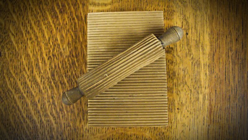 Goffering block and roller, inscribed on the back, ‘Hannah Barnbridge Craig 1804’. This is one of two preserved sets that could be used on collars, cuffs, nightcaps and other aspects of clothes that needed crimping and goffering. The model is made entirely of wood with a grooved wooden block, 10 x 15 cm, and a matching small grooved roller; such a model was in use as early as the 18th century. (Collection: Whitby Museum, Social History, SOH 370). Photo: Viveka Hansen, The IK Foundation.  