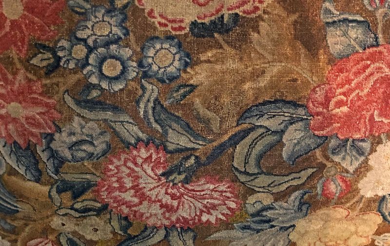 The second studied embroidery included very similar type of flowers, upholstered on an English mahogany sofa and dated to circa 1745. However, a noticeable difference between the two canvas embroideries is the fineness and density of the stitching. This illustrated upholstery, stitched with wool and some minor details of silk, is clearly much finer in quality (tent stitches over one thread of the canvas only), which gave the design a potential to be more natural in all details. One may even come to the conclusion due to its complexity, that this particular large-scale embroidery for a sofa was made by a professional embroiderer for a wealthy household. In contrast to the chair covers (illustrated above and below), which most probably could have been made by a lady during her leisure time as a beautiful handicraft for practical use in the family home. (Collection: David Collection in København, Denmark. No. 22/1971). Photo: Viveka Hansen, The IK Foundation.