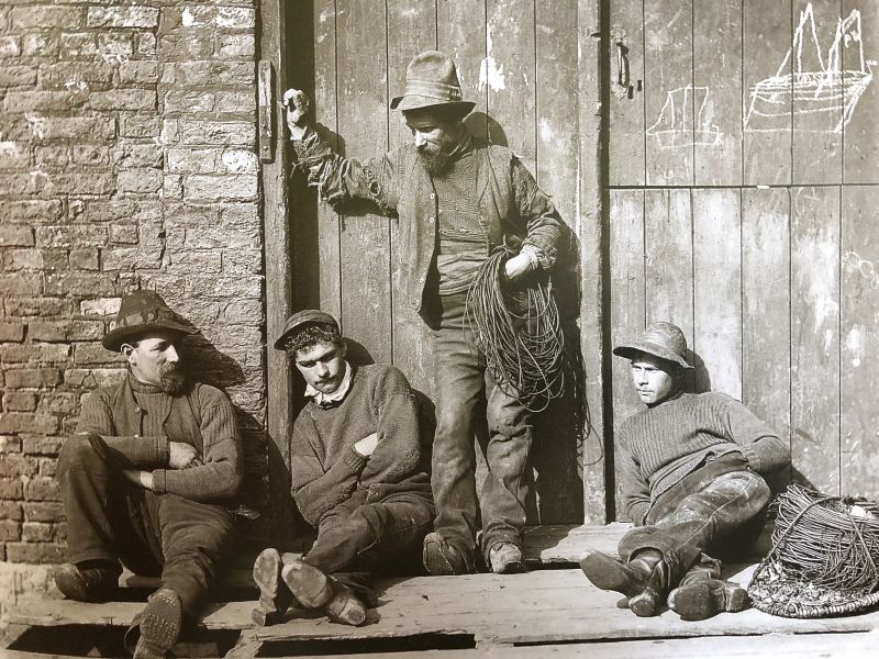 Daily wear and tear, together with various darning, is even more evident in this portrait by Frank Meadow Sutcliffe dated around 1900 – of four Whitby fishermen wearing their working garments. In particular visible on the elbows of their knitted woollen ganseys. (Courtesy: Whitby Museum, Photographic Collection, Sutcliffe, 4-34).