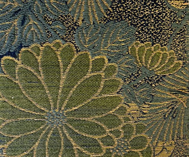 A close-up detail from the sample catalogue, including 22 pages, highlights the delicate silk brocade design style and colours used in this Japanese collection. The preferred choice of highly advanced weaving techniques is also visible here, with more than one warp system, resembling a figured satin weave. A decorative fabric like this, with relative sturdiness without long floating weft threads and great beauty, was often used for kimonos for centuries. (Collection: Design Museum Denmark, København. |The Library. Sample Book: I19072 Ø004). Photo: Viveka Hansen, The IK Foundation.