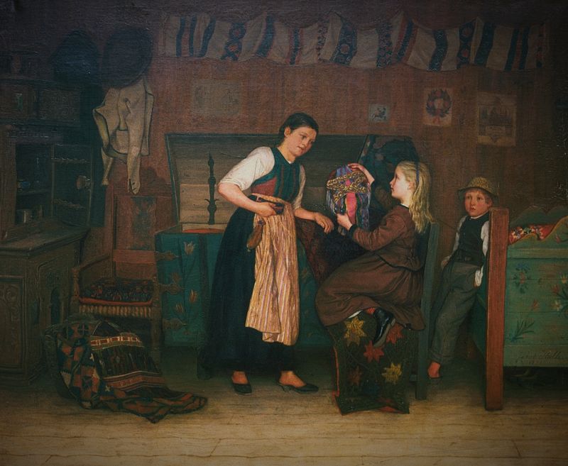‘In the chest chamber’ by the artist Jakob Kulle from 1875, demonstrates how art woven textiles inherited through generations were kept safe in a wooden decorated chest. This due to the long-lived tradition to include a multitude of woven and embroidered textiles in the young bride’s dowry in the well-to-do farming communities. Particular in the southern districts of the province Skåne. It seems like the girl wearing a brown fashionable dress is looking at the old treasures, explained by the traditionally dressed young woman. Judging by the design of the cushion cover with star motifs displayed on the chair, it looks to have been woven in the partly-piled “halvflossa”, a popular technique in this area up to about 30-40 years prior to this artwork. (Owner: Malmö Museum. Photo: The IK Foundation, London).