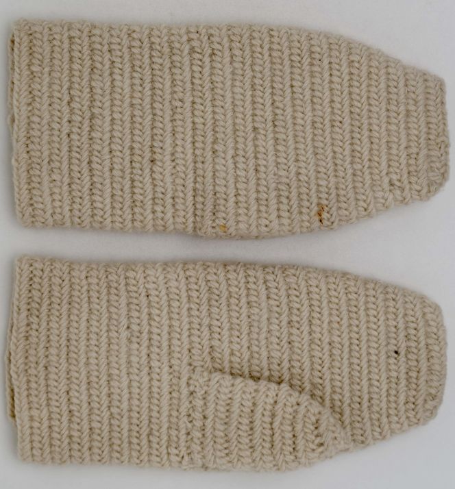 Traditional white woollen mittens in the nålbindning technique. This pair of mittens was donated to the Nordic Museum in 1933 by the Countess Ulla von Celsing at Biby manor house, situated about 100 kilometres from Stockholm. Interestingly, this manor house had a large sheep-breeding farm, so-called ‘schäferi’, particularly substantial in size from the 1820s to the 1860s. Wool samples of various qualities were also meticulously arranged in the account books. Such a sample book from 1860 has been presented in the book ‘Biby: Ett fideikommiss berättar’ (see sources). One may assume and it is even highly likely, that the wool as well as the ready-made mittens, originate from the 19th century sheep-breeding period at Biby or the farms placed under this manor house. (Courtesy: The Nordic Museum, Stockholm, Sweden. No: NM.0195572A-B. Digitalt Museum).