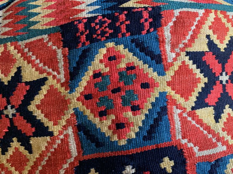 Placing one’s initials, a year, or a geographical place on possessions or produced goods is a tradition that stretches back through Nordic heritage, including many woven interior textiles for the home and the young woman’s dowry. Amongst the documented double interlocked tapestries – rölakan from this research of almost 1,700 examples – it can be stated that barely 20% of the textiles have some markings. These are positioned in various ways: on an empty background surface, alongside other smaller motifs, by replacing the motif with markings, in the borders or within a star motif. The markings are comprised of dates, names, places of birth or other details. These signatures were commonly added during weaving, but embroidered markings were also used. It is worth noticing that specific ornamentation, incredibly complex and compact weaves, had, in turn, a much higher percentage of markings. On this particular travel cushion, the year “1817” is clearly visible, with the initials ‘HD’ illustrated in the picture below. (Private ownership). Photo: The IK Foundation.