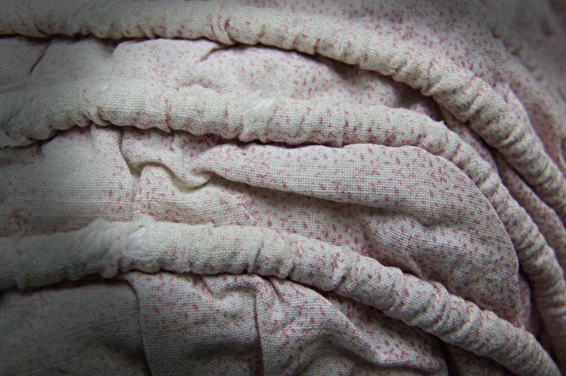 For both portrayed women above, it is detectable that the chosen fabric had small-scale motifs or a checked structure of either printed or woven cotton. This is one typical example of material and design on one of the bonnets in the Whitby Museum collection. The raised longitudinal corded bands are also in focus on this close-up detail of a traditional bonnet of printed cotton. (Collection: Whitby Museum, Costume Collection, C11). Photo: Viveka Hansen, The IK Foundation.