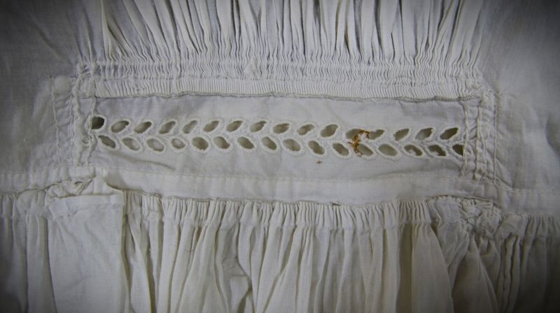 Close-up detail of stitching on a christening gown. A garment that was entirely hand-stitched – probably in the 1830s or 1840s – judging from the particularly fine gathering at the back that was such a common feature of women’s clothes at the time. This well-worked christening gown in fine cotton batiste has been finished with exquisite smocking, gathering, pleating, bobbin lace, cutwork and broderie anglaise. (Collection: Whitby Museum…, Costume Collection, GBI 1). Photo: Viveka Hansen, The IK Foundation. 
