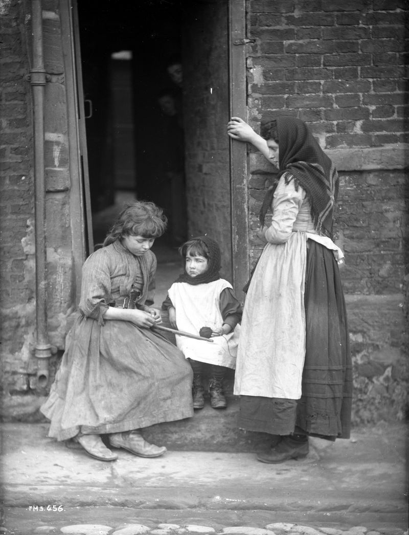 This photograph by Frank Meadow Sutcliffe shows what was a reality for many Whitby families about 1900 – not only individuals occupied in the rag trade. The ragged clothes of the children outside the door of their home exemplify the varied garments of the children of the poor at various ages. (Courtesy of: Whitby Museum, Photographic Collection, Sutcliffe A19.) 
