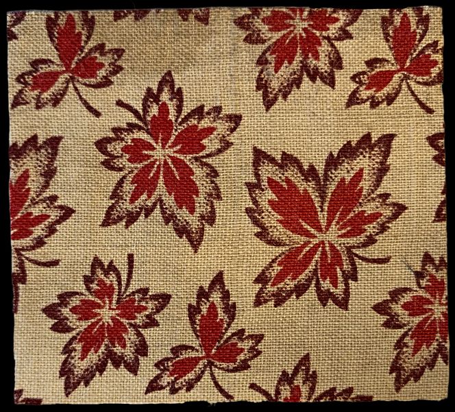 A second detail is quite different. A leaf motif in two colours was printed on plain-woven fibre ramie or hemp fabric. Decorating fabrics with dyes using various techniques has a long history in many countries, including Japan. For this particular sample, two stencils were used, one at a time, for the two red shades. The stencil design was relatively small due to the repetitive small leaf motif. It was also common to apply rice paste to the fabric before dyeing to protect the undyed ground, a paste that was easily washed away after the dyes had dried completely. Notably, this is the only dyed motif in the two studied sample catalogues. (Collection: Design Museum Denmark, København. The Library. Sample Book: I19072 Ø004). Photo: Viveka Hansen, The IK Foundation.