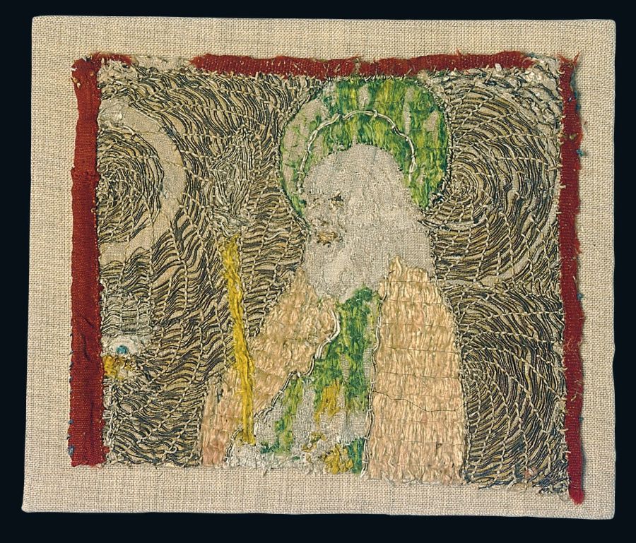 This fragmented and worn piece of a late Medieval embroidery in laid work, gives a detailed view of the  embroiderer’s work; we can get a close-up of the careful design and position of each and every stitch, the use  of silks and metallic threads together with glimpses of the typical plain-woven unbleached foundation.  The fragment is today stitched on an additional linen for a stabilisation of its frail state. Height 17 cm  and width 19,5 cm. Photo: The IK Foundation, London.