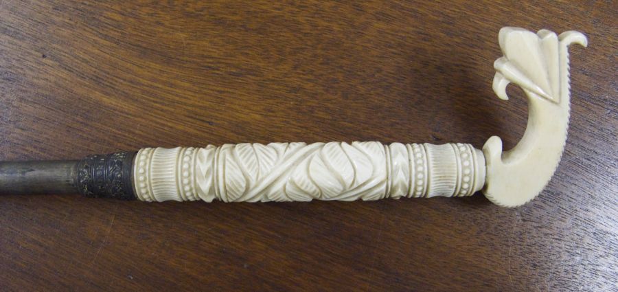 Close-up of the ornamented ivory handle, notice that the ivory top and handle may be older than the rest of the umbrella which dates to the late Victorian period. It was probably common to re-use the frames, tops and handles – particularly if these parts were of expensive types – when the worn fabric was replaced with a new cloth. (Whitby Museum, Costume Collection, GBZ 58). Photo: Viveka Hansen.