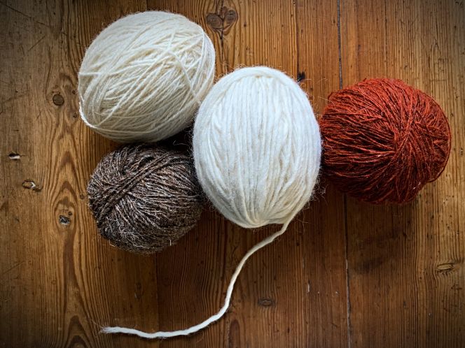 Examples of wools wound into yarn balls – made up on the 19th-century yarn winder as illustrated above. Even if most winding over time seems to have been done in the shape of round balls, oval-winded balls are another option. Machine-spun undyed single-ply wools and madder-dyed red wool, as shown here. (Private Collection). Photo. Viveka Hansen.