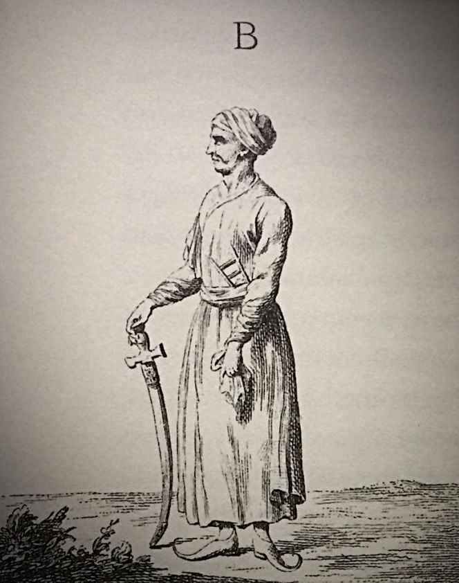 Observations of how the Indian merchants dressed in white cotton, was mentioned among other reflections: ‘The sleeves in this dress are very long, but narrow and pushed back over the hand. They have a belt around the hips; their slippers are big and are crooked in the front like our walking shoes or the Finnish Lapps’ [Sami] shoes. In the ears they carry large golden rings, and the rich merchants also like a large-size real pearl in each ear. The shape of their turban, the knife they hold in front of the stomach, in short, the whole inner garment is different from the Arabs, the Turks and the Persians, but also very comfortable in this climate.’ (From: Niebuhr…1778. Tab. XII B).