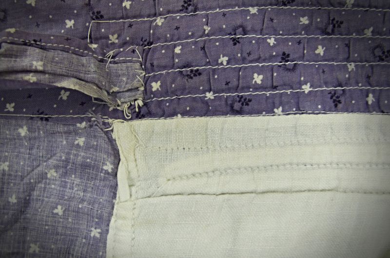 A second example shows the white lining and how the machine stitching was part of the overall design of the printed purple cotton quality. Like the one illustrated above, this bonnet originates from an unknown owner living in or around Whitby circa 1890s-1910s. During the research of censuses from the period 1841 to 1911, though, the only woman who specifically described herself as a ’bonnet maker’ was the 57-year-old widow Mary Harrison, who lived in Church Street in 1871. In the following decades, bonnets were also sold in a shop on the High Street in the coastal village of Staithes. Equally, it may be assumed that such headgear was sewn locally at home or by seamstresses in the Whitby area. (Collection: Whitby Museum, Costume Collection, C12). Photo: Viveka Hansen, The IK Foundation.