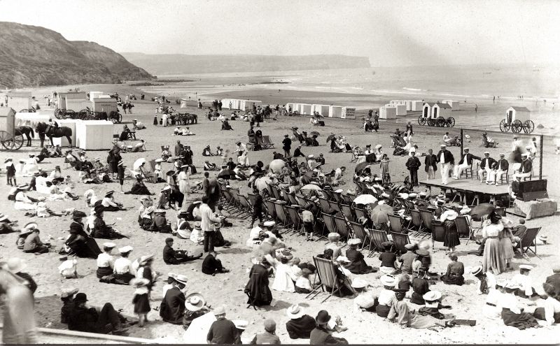 It can be supposed that visitors during the summer months found fashion columns of interest, and many possibly needed to supplement their wardrobes with garments suitable for sun, beach and leisure in local shops. Snapshot by unknown photographer ca 1905 – ‘Entertainment on the beach’. (Courtesy of: Whitby Museum, Photographic Collection, C 528. (Whitby Lit. & Phil.).