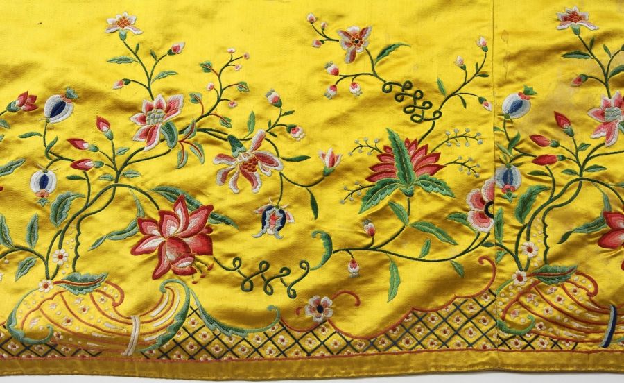 This exquisite yellow silk atlas skirt with multicoloured silk embroidery demonstrates the demand not only for the materials in themselves but also for readymade garments, which originated from the Swedish East India Company trade in Canton. The design is made in a European-inspired style with popular rococo motifs. According to the Nordic Museum’s references, the delicate garment was interestingly enough brought back to Sweden by the East India Company captain Mathias Holmers during the 1750s and, together with other objects linked to 18th century Canton, sold to the museum in 1944. It is also highly probable that the exquisite garment had been carried back on an East India ship before the total import ban of silk fabrics in 1756 – even if the museum catalogue card gives the date 1758 for Holmer’s ownership. (Courtesy: The Nordic Museum.… NM.0230805, part of the skirt, DigitaltMuseum).