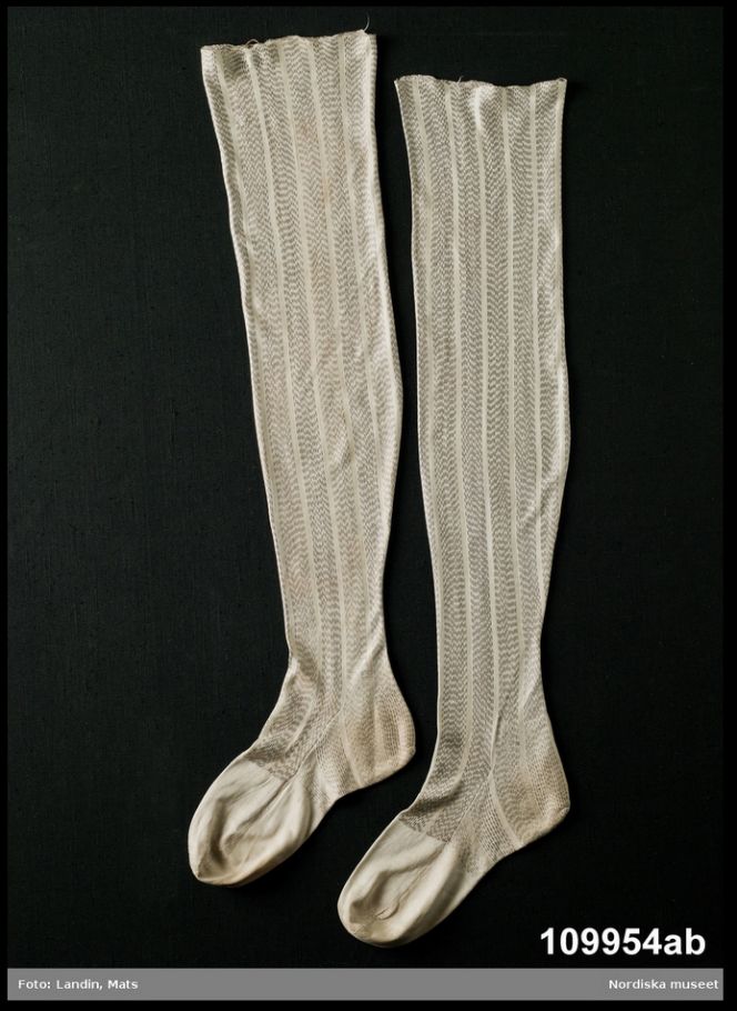 It is rather rare to find comparable clothing to 18th century fashion drawings, but these fine silk stockings are one such exception which looks almost identical in design, shape as well as material. These machine knitted long stockings of silk, may also be compared to some men’s fashion in printed German journals from 1789 and 1794. These two journals – Journal des Luxus und der Moden (June 1789) and Journal für Fabrik, Manufactur, Handlung und Mode (February 1794) – have been studied by Lena Rangström in her research of male fashion from this period (pp. 237-238). (Courtesy of: The Nordic Museum NM.0109954A-B).