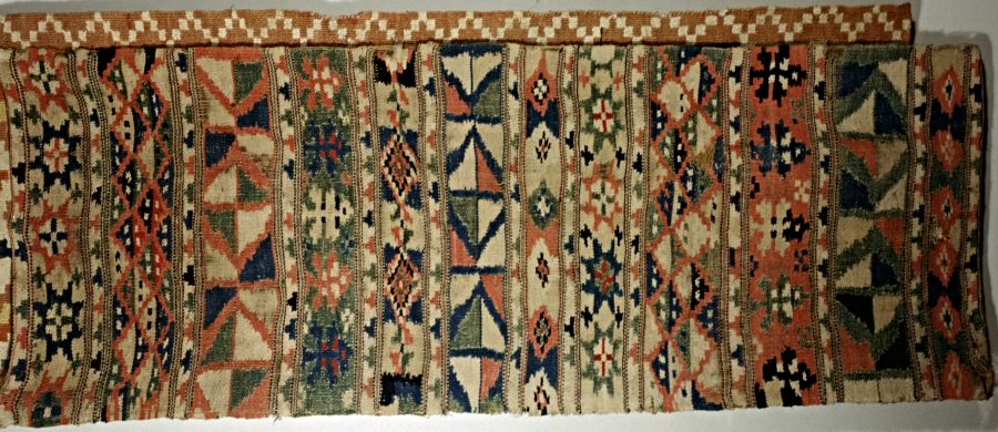 The second example is a bench cover woven in double-interlocked tapestry – rölakan from Blekinge province. The design comprised narrow T-borders and varied geometrical- and star motifs for the broader borders. (Collection: Karlshamns Museum, Sweden. No: 12059). Photo: The IK Foundation.