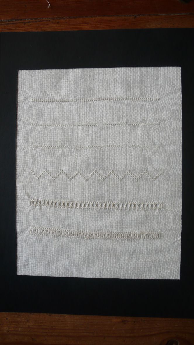 The second attempt includes six variation of whitework, embroidered on the same type of linen with  14 threads/cm. Two qualities of strong linen thread (2 ply- and 3-ply) were used, to achieve the effects  similar to the early 19th century embroideries made in southern Skåne. From top the stitchings are:  1. ordinary Holbein stitch, 2 & 3 variations of Holbein stitch, 4. diagonal Holbein stitch, 5 & 6.  drawn-thread work “H-hålsöm” and “stoppad hålsöm”. Photo and embroidery: Viveka Hansen.