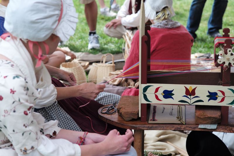 Tape loom weaving – historical reenactment on 4th July 2014 at National Constitution Centre in Philadelphia. Notice the loom design as well as the weaving technique and the clear resemblance with the two images above depicting 18th century box tape looms. Photo: The IK Foundation, London.