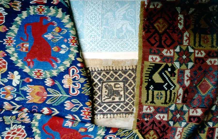 This photograph shows a selection of textiles with lions; two colourful tapestries woven by farmers’ wives and daughters of south eastern Skåne (late 18th century), together with a Coptic textile (5th to 7th century AD) and Italian filet lace (16th century). (Owner: Malmö museums). Photo: The IK Foundation, London.